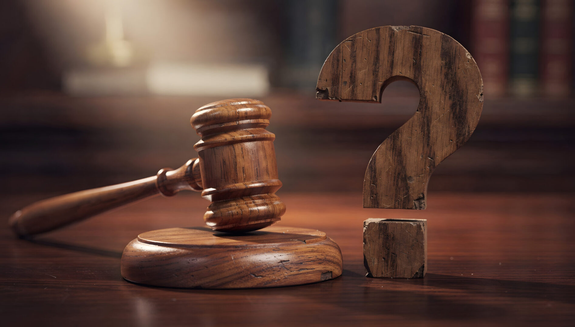 Gavel beside wooden question mark, legal concept