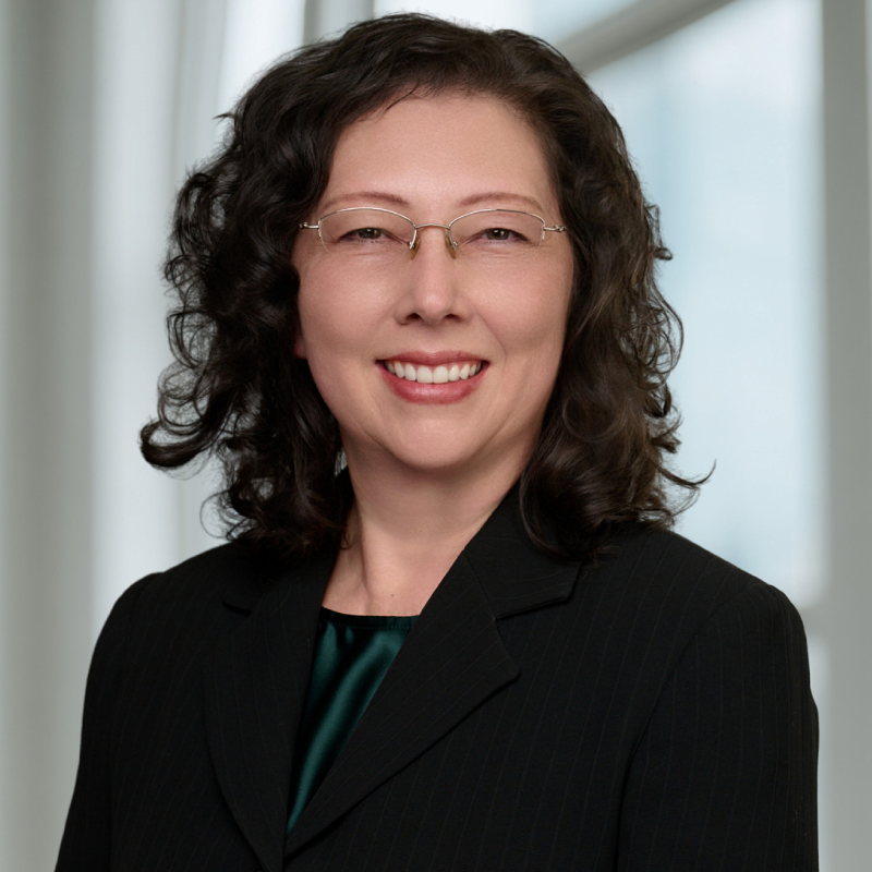 Smiling professional woman in suit and glasses